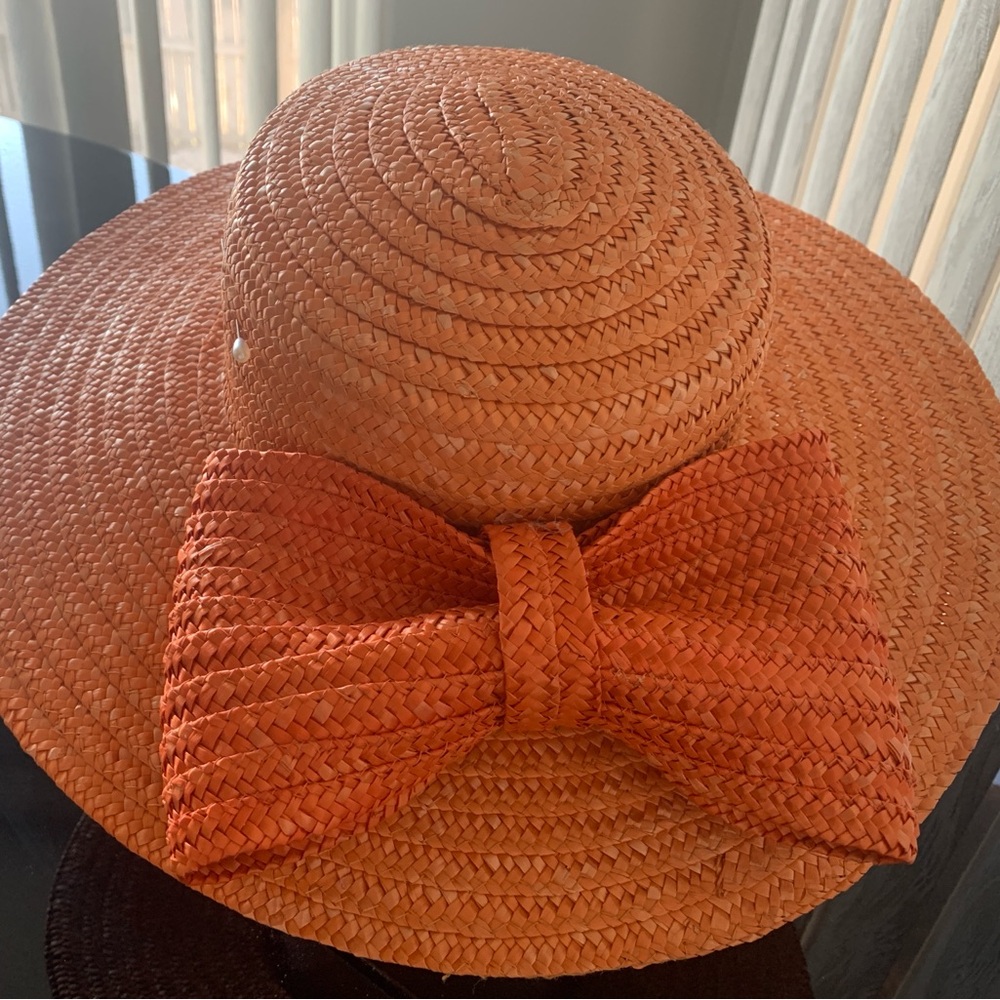 Sisley made In Italy orange straw hat. Adorned with orange straw bow Never Worn
